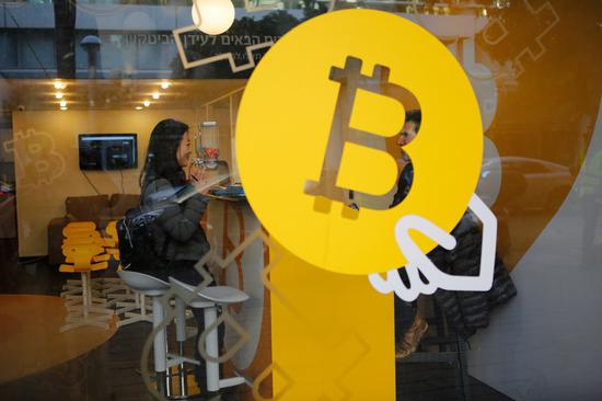 A woman buys Bitcoin at Bitcoin Change in Tel Aviv, Israel, on Jan. 8, 2018. (Xinhua/Gil Cohen Magen)