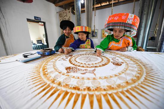 Miao women make Batik painting in Sichuan