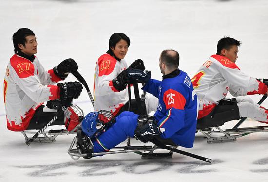 Yu Jing (2nd L) of China greets Francesco Torella (2nd R) of Italy after the para ice hockey preliminary round Group B match of the Beijing 2022 Paralympic Winter Games at National Indoor Stadium in Beijing on March 8, 2022. (Xinhua/Zhang Bowen)