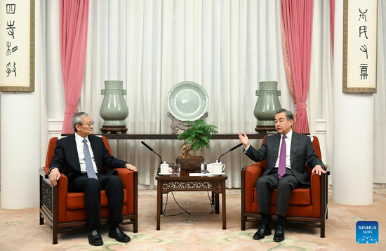 Chinese State Councilor and Foreign Minister Wang Yi meets with Shanghai Cooperation Organization Secretary-General Zhang Ming in Beijing, capital of China, March 17, 2022. (Xinhua/Zhang Ling)
