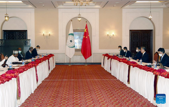 Chinese State Councilor and Foreign Minister Wang Yi (2nd R) meets with Secretary-General of the Organization of Islamic Cooperation (OIC) Hissein Brahim Taha (1st L) in Islamabad, capital of Pakistan, on March 22, 2022. (Xinhua/Ahmad Kamal)