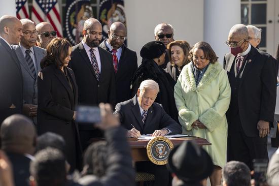 U.S. President Joe Biden signs the Emmett Till Anti-Lynching Act in the Rose Garden of the White House in Washington, D.C., the United States, on March 29, 2022. (Xinhua/Liu Jie)