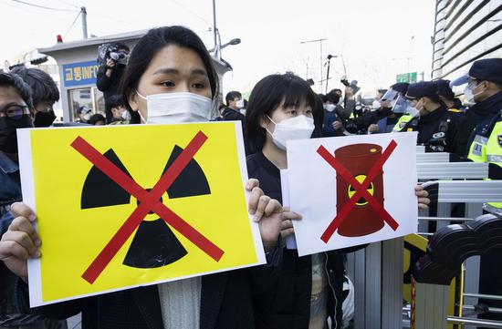 People protest against Japan's decision to dump radioactive wastewater from the crippled Fukushima Daiichi nuclear power plant into the Pacific Ocean outside Japanese embassy in Seoul, South Korea, April 14, 2021. (Photo by Xu Ruxi/Xinhua)