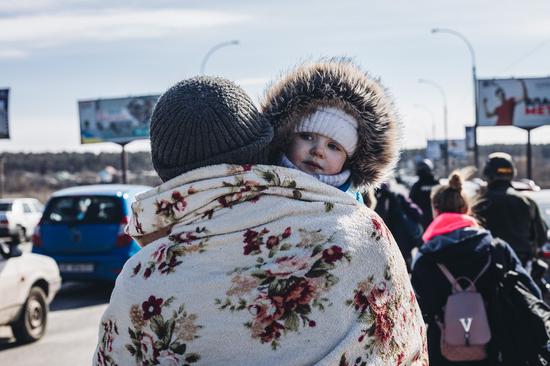 People evacuate in Irpin, Ukraine, March 11, 2022.  (Photo by Diego Herrera/Xinhua)