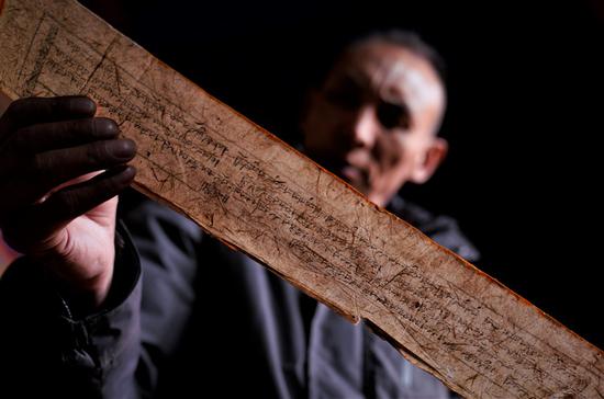 A conservator of the Potala Palace registers an ancient document in Lhasa, capital of southwest China's Tibet Autonomous Region, Nov. 16, 2018. (Xinhua/Purbu Zhaxi)