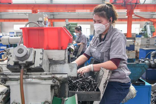 A worker works at an auto parts company in Jilin City, northeast China's Jilin Province, April 19, 2022. Local enterprises have been resuming production under strict COVID-19 prevention and control measures. (Xinhua/Zhang Nan)