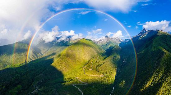Aerial photo taken on July 6, 2021 shows a rainbow over the highway linking counties of Milin and Medog in Nyingchi, southwest China's Tibet Autonomous Region. (Photo by Dong Zhixiong/Xinhua)