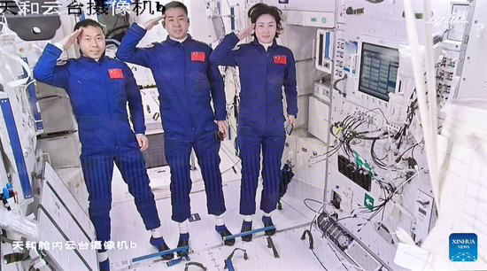 Screen image captured at Beijing Aerospace Control Center on June 5, 2022 shows three Chinese astronauts, Chen Dong (C), Liu Yang (R) and Cai Xuzhe, saluting after entering the space station core module Tianhe. (Photo/Xinhua)