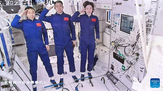 Screen image captured at Beijing Aerospace Control Center on June 5, 2022 shows three Chinese astronauts, Chen Dong (C), Liu Yang (R) and Cai Xuzhe, saluting after entering the space station core module Tianhe. (Xinhua/Li Xin)