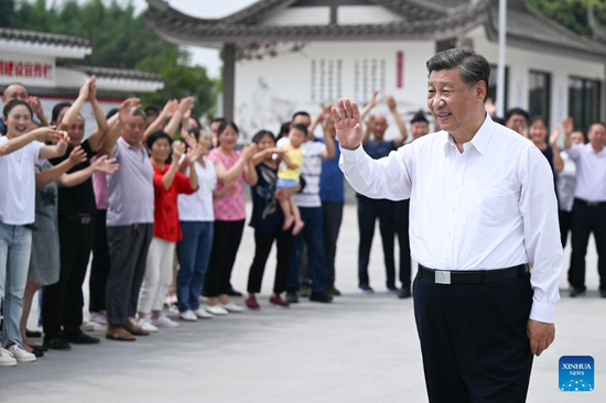 Chinese President Xi Jinping, also general secretary of the Communist Party of China Central Committee and chairman of the Central Military Commission, waves to villagers while visiting the village of Yongfeng to learn about local efforts in advancing high-standard farmland development, boosting grain production, promoting rural revitalization, maintaining effective COVID-19 prevention and control, in Meishan, southwest China's Sichuan Province, June 8, 2022. (Xinhua/Xie Huanchi)

