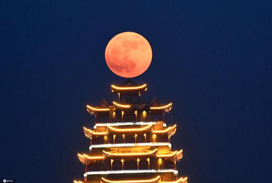 Strawberry supermoon lights up night sky across China