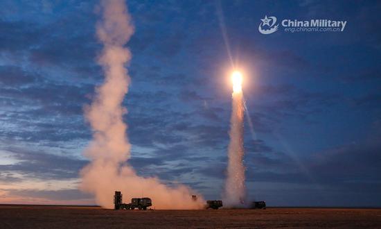 Medium-range air-defense missile system attached to a missile battalion of an air-defense brigade under the PLA 72nd Group Army fires a surface-to-air missile during a recent round-the-clock air-defense training exercise in northwest China’s Gobi desert. (Photo/China Military)