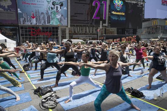 People perform Yoga to greet Summer Solstice in New York