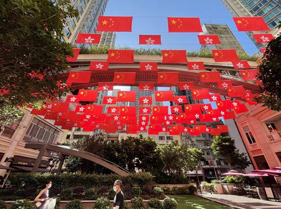 China's national flags and the Hong Kong Special Administrative Region (HKSAR) flags fly along the Lee Tung Avenue in Hong Kong, south China, June 28, 2022. (Xinhua/Li Gang)