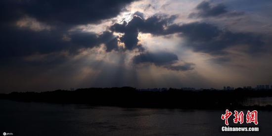 Light rays shine through clouds after rain in Harbin