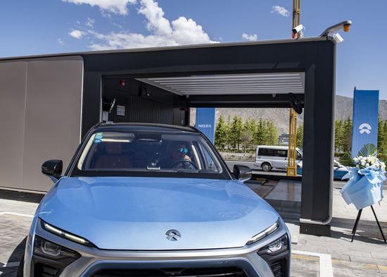 Cai Junbo from south China's Hainan Province experiences the battery-swap service at a battery-swap station in Lhasa, southwest China's Tibet Autonomous Region, July 6, 2022.  (Xinhua/Lyu Qiuping)