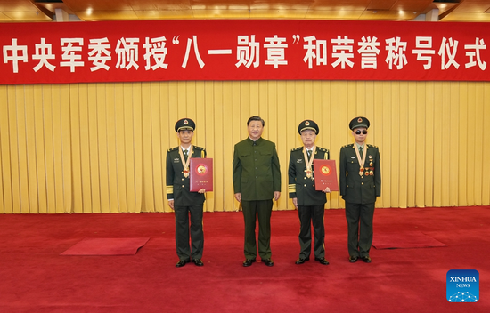 Chinese President Xi Jinping, also general secretary of the Communist Party of China Central Committee and chairman of the Central Military Commission, takes photos with the recipients of the August 1 Medal in Beijing, capital of China, July 27, 2022. Xi on Wednesday presented the August 1 Medal to three military servicemen and conferred an honorary flag to a military battalion for their outstanding service ahead of the 95th anniversary of the founding of the Chinese People's Liberation Army. (Xinhua/Li Gang)