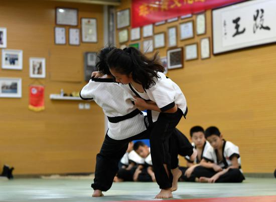 Teenagers practice Kungfu wrestling in summer break