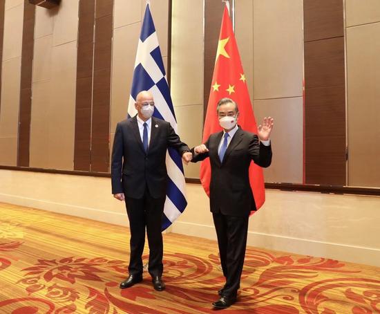 Chinese State Councilor and Foreign Minister Wang Yi (R) meets with Greek Foreign Minister Nikos Dendias on the sidelines of the East Asia Summit Foreign Ministers' meeting in Phnom Penh, Cambodia, Aug. 3, 2022. (Xinhua/Wu Changwei)