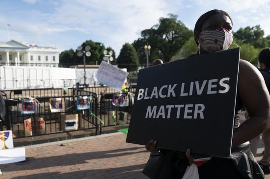 A demonstrator protests against racial injustice to mark Juneteenth, which commemorates the end of slavery in the United States, near the White House in Washington, D.C., the United States, June 19, 2020.(Xinhua/Liu Jie)