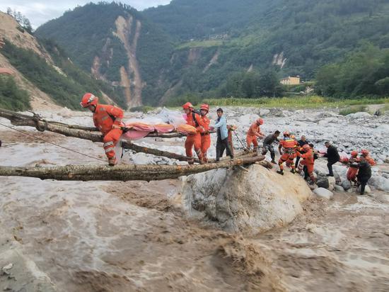 Rescuers transfer a survivor in Moxi Town of Luding County, southwest China's Sichuan Province, Sept. 5, 2022. A 6.8-magnitude earthquake jolted Luding on Monday. (Photo by Hong Fule/Xinhua)