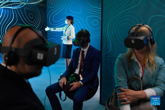 People interact with VR presentation during the 7th Eastern Economic Forum (EEF) in Vladivostok, Russia, Sept. 5, 2022. The 7th EEF kicked off in Russia's far eastern city of Vladivostok on Monday. (Photo by Alexander Zemlianichenko Jr/Xinhua)