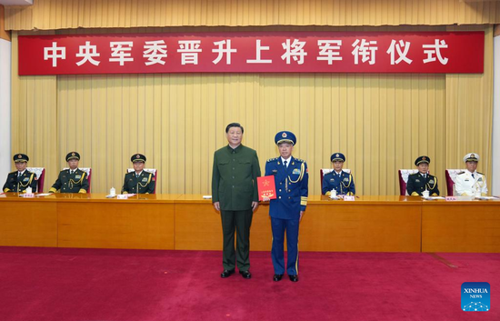 Xi Jinping, chairman of the Central Military Commission (CMC), presents a certificate of order at a ceremony to promote Wang Qiang, commander of the Northern Theater Command of the People's Liberation Army, to the rank of general, in Beijing, capital of China, Sept. 8, 2022. The ceremony was held by the CMC in Beijing. (Xinhua/Li Gang)