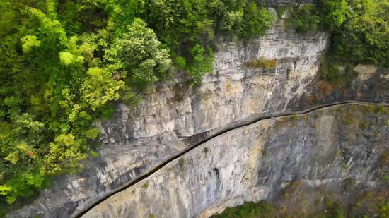Canal constructed along cliff benefits locals for 40 years