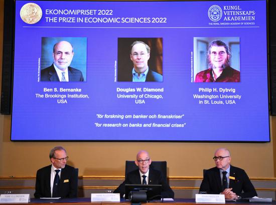 Portraits of the 2022 Nobel laureates in Economic Sciences Ben S. Bernanke (L), Douglas W. Diamond (C) and Philip H. Dybvig are seen on a screen during the prize announcement in Stockholm, Sweden, Oct. 10, 2022. (Xinhua/Ren Pengfei)