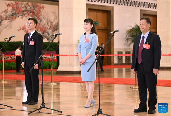 Delegates to the 20th National Congress of the Communist Party of China (CPC) Zhou Wei, Yang Yu and Lin Zhanxi (from L to R), attend an interview at the Great Hall of the People in Beijing, capital of China, Oct. 16, 2022. The CPC will open its 20th national congress on Sunday. (Photo/Xinhua)