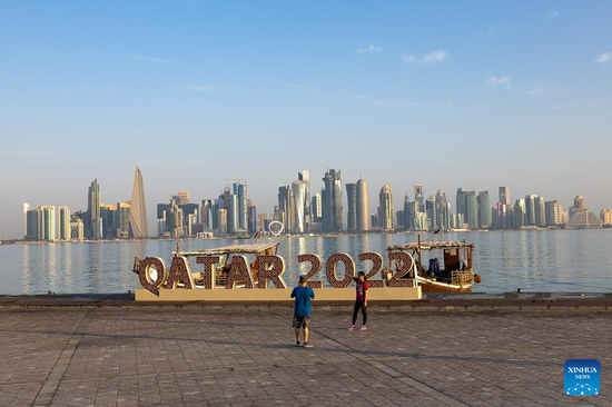 People take photos with a FIFA World Cup 2022 installation near the Doha Corniche in Doha, Qatar, on Nov. 11, 2022. (Photo/Xinhua)

