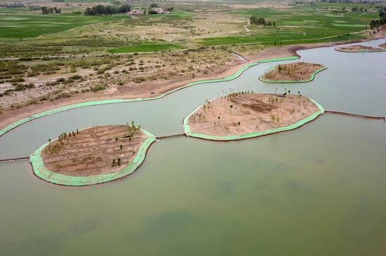 Aerial photo taken on June 10, 2021 shows a water system under construction in Linze County, Zhangye City, northwest China's Gansu Province. Linze County is located in the southern edge of Badain Jaran Desert, the third largest desert in China, with Heihe River, China's second largest inland river, passing through the county.   (Xinhua/Fan Peishen)