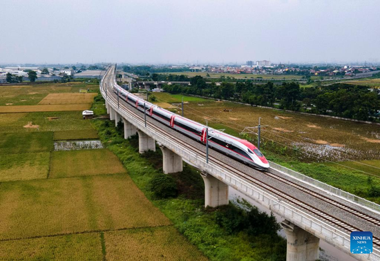This aerial photo taken on Nov. 9, 2022 shows electric multiple units being tested for hot-running on the Jakarta-Bandung High-Speed Railway trial section in Bandung, Indonesia. With a design speed of 350 km per hour, the railway is a flagship project that synergizes the China-proposed Belt and Road Initiative and Indonesia's Global Maritime Fulcrum strategy. Built with Chinese technology, it is a model of cooperation between developing countries. (Photo by Jiao Hongtao/Xinhua)

