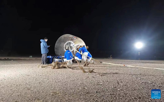 The return capsule of the Shenzhou-14 manned spaceship touches down safely at the Dongfeng landing site in north China's Inner Mongolia Autonomous Region, Dec. 4, 2022. (Xinhua/Li Gang)