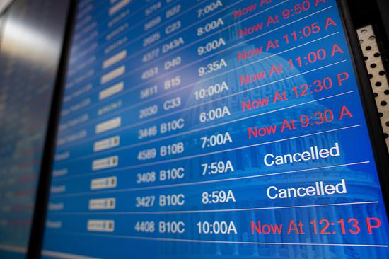 A flight information screen is seen at Ronald Reagan Washington National Airport in Arlington, Virginia, the United States, Jan. 11, 2023. (Xinhua/Liu Jie)