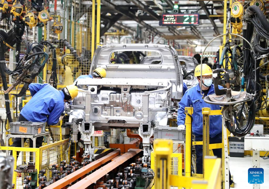 Staff members work at a workshop of an auto manufacturing enterprise in Qingdao, east China's Shandong Province, Jan. 28, 2023. Factories and companies across China resumed work after the Spring Festival holiday. (Photo by Zhang Jingang/Xinhua)