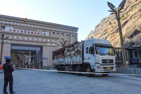 A truck loaded with goods from Nepal enters the Gyirong port in southwest China's Tibet Autonomous Region, Dec. 28, 2022. (Photo by Shen Shuwen/Xinhua)