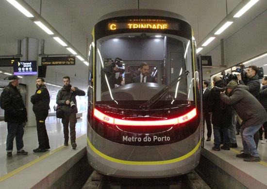 Portuguese Minister of Environment and Climate Action Duarte Cordeiro (C) sits in the driver's cab of a China-made metro train inside the Trindade Metro Station at the center of Porto, Portugal, Feb. 11, 2023.(Xinhua/Wen Xinnian)