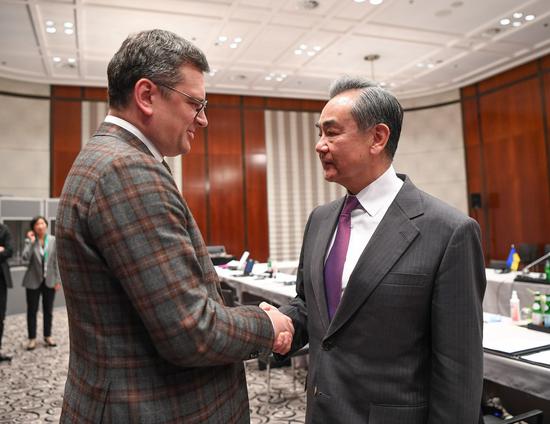 Wang Yi (R), a member of the Political Bureau of the Communist Party of China (CPC) Central Committee and director of the Office of the Foreign Affairs Commission of the CPC Central Committee, meets with Dmytro Kuleba, Ukrainian foreign minister, on the sidelines of the 59th Munich Security Conference in Munich, Germany on Feb. 18, 2023. (Xinhua/Ren Pengfei)

