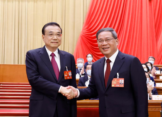 Li Qiang (R, front) shakes hands with Li Keqiang at the fourth plenary meeting of the first session of the 14th National People's Congress (NPC) at the Great Hall of the People in Beijing, capital of China, March 11, 2023. The fourth plenary meeting of the first session of the 14th NPC was held on Saturday. Li Qiang was endorsed as Chinese premier at the meeting upon nomination by President Xi Jinping. (Xinhua/Huang Jingwen)