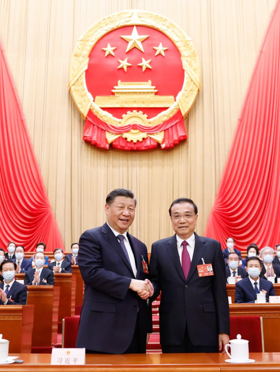 Xi Jinping shakes hands with Li Keqiang at the fourth plenary meeting of the first session of the 14th National People's Congress (NPC) at the Great Hall of the People in Beijing, capital of China, March 11, 2023. The fourth plenary meeting of the first session of the 14th NPC was held on Saturday. Li Qiang was endorsed as Chinese premier at the meeting upon nomination by President Xi Jinping. (Xinhua/Huang Jingwen)