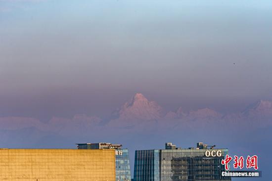 Mount Siguniang 'floats' over Chengdu skyline