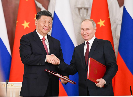 Chinese President Xi Jinping and Russian President Vladimir Putin shake hands after jointly signing a Joint Statement of the People's Republic of China and the Russian Federation on Deepening the Comprehensive Strategic Partnership of Coordination for the New Era and a Joint Statement of the President of the People's Republic of China and the President of the Russian Federation on Pre-2030 Development Plan on Priorities in China-Russia Economic Cooperation in Moscow, Russia, March 21, 2023. Xi on Tuesday held talks with Putin at the Kremlin in Moscow. (Xinhua/Xie Huanchi)