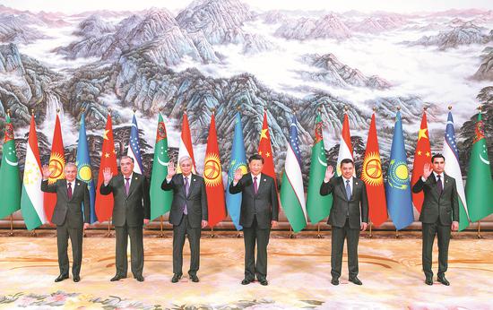 President Xi Jinping and visiting leaders of five Central Asian countries wave as they pose for pictures at a group photo session during the China-Central Asia Summit in Xi’an, Shaanxi province, on Friday. (Feng Yongbin/China Daily)