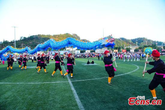 Villagers perform dragon dance during the match break at Hemei Village of Rongjiang County, Qiandongnan Miao and Dong Autonomous Prefecture, southwest China's Guizhou Province, June 3, 2023. (Photo provided to China News Service)