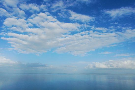 Magnificent scenery of colors of Erling Lake and sky merging on horizon