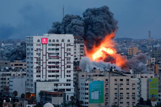 A ball of fire and smoke rises above a building in Gaza City during an Israeli air strike, Oct. 7, 2023. (Photo/Agencies)