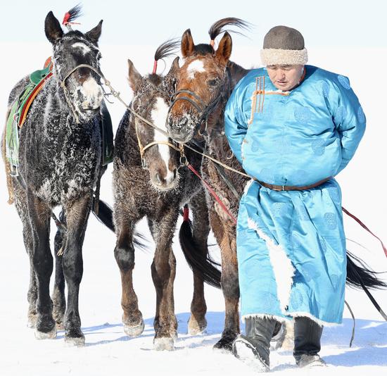 Horse race on snowy grassland in Inner Mongolia