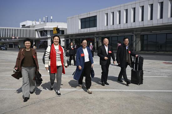 Members of the national political advisory board arrive in Beijing for national session