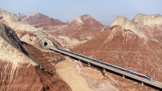 Spectacular view of train running through Danxia landform